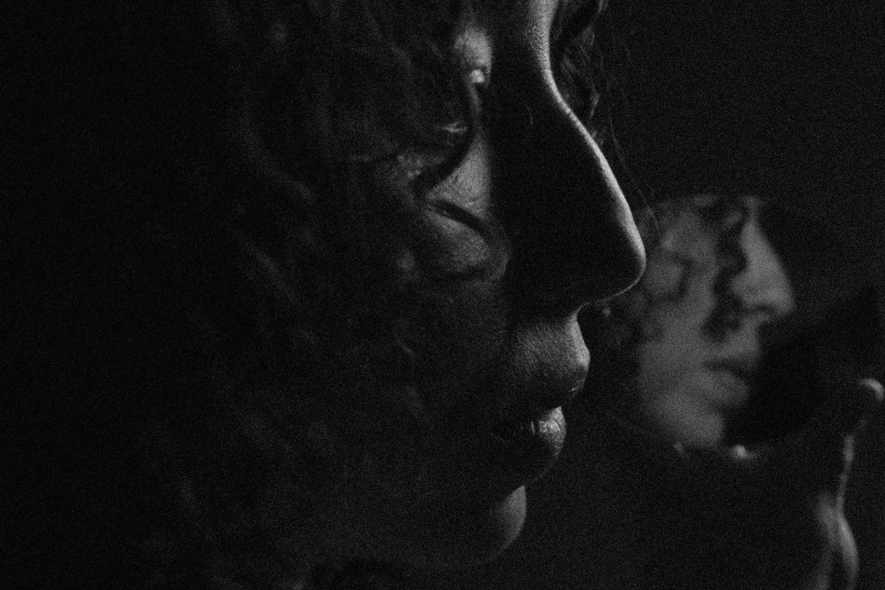 Black and white close-up of a person's face with a blurred background