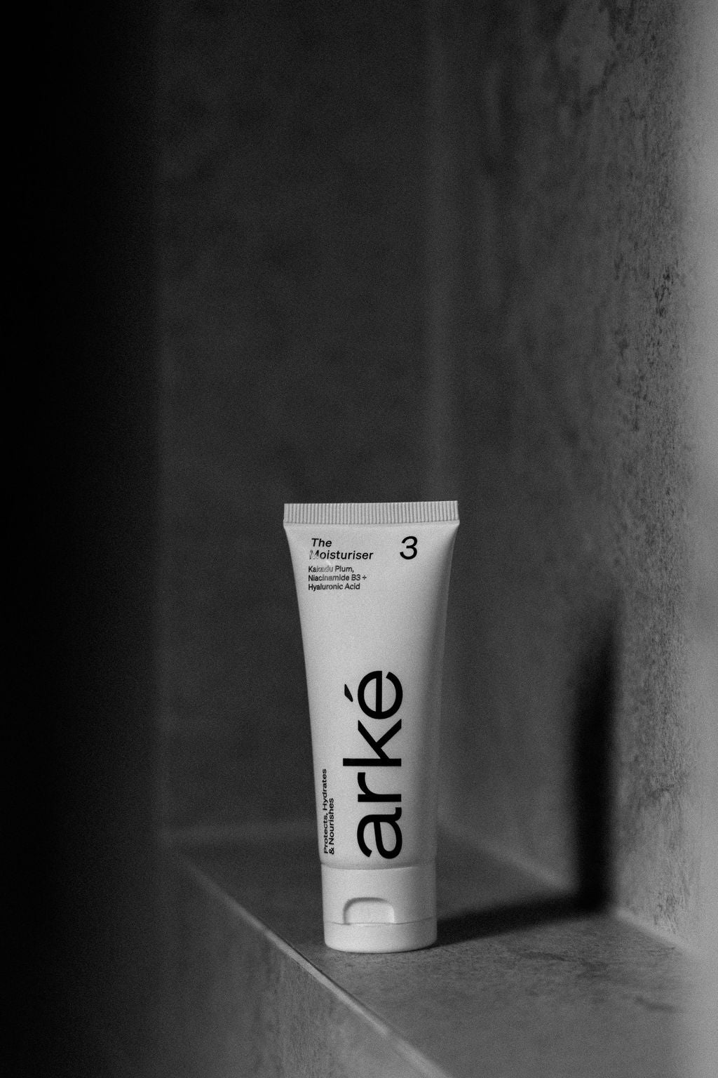 Tube of arke moisturiser on a small ledge