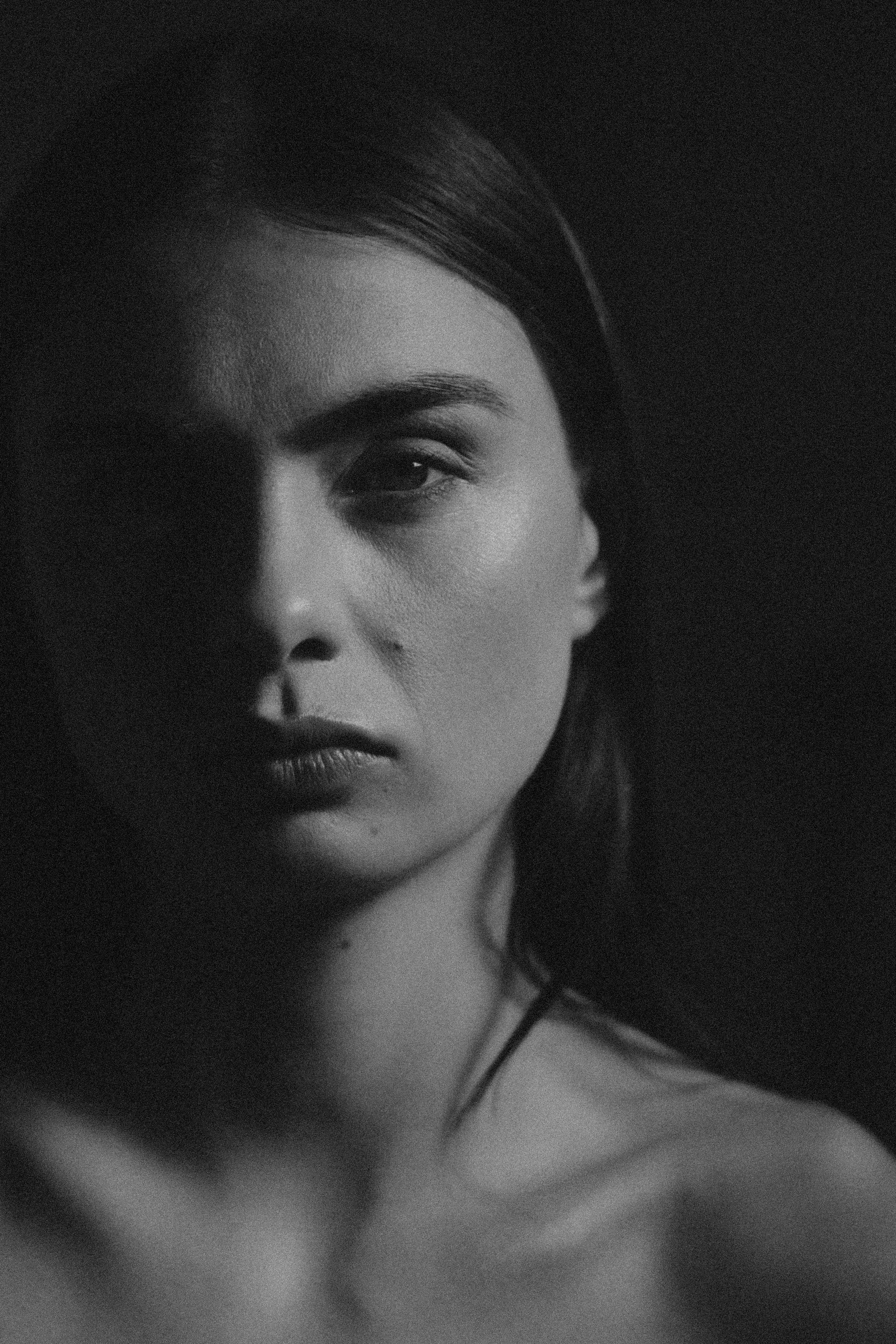 Black and white portrait of a woman with dramatic lighting
