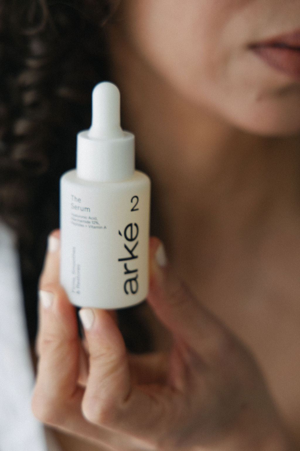 Woman holding arke serum with a blurry effect